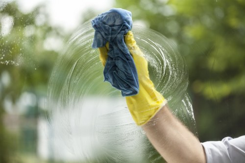 A cleaner using approved safety procedures while handling cleaning products